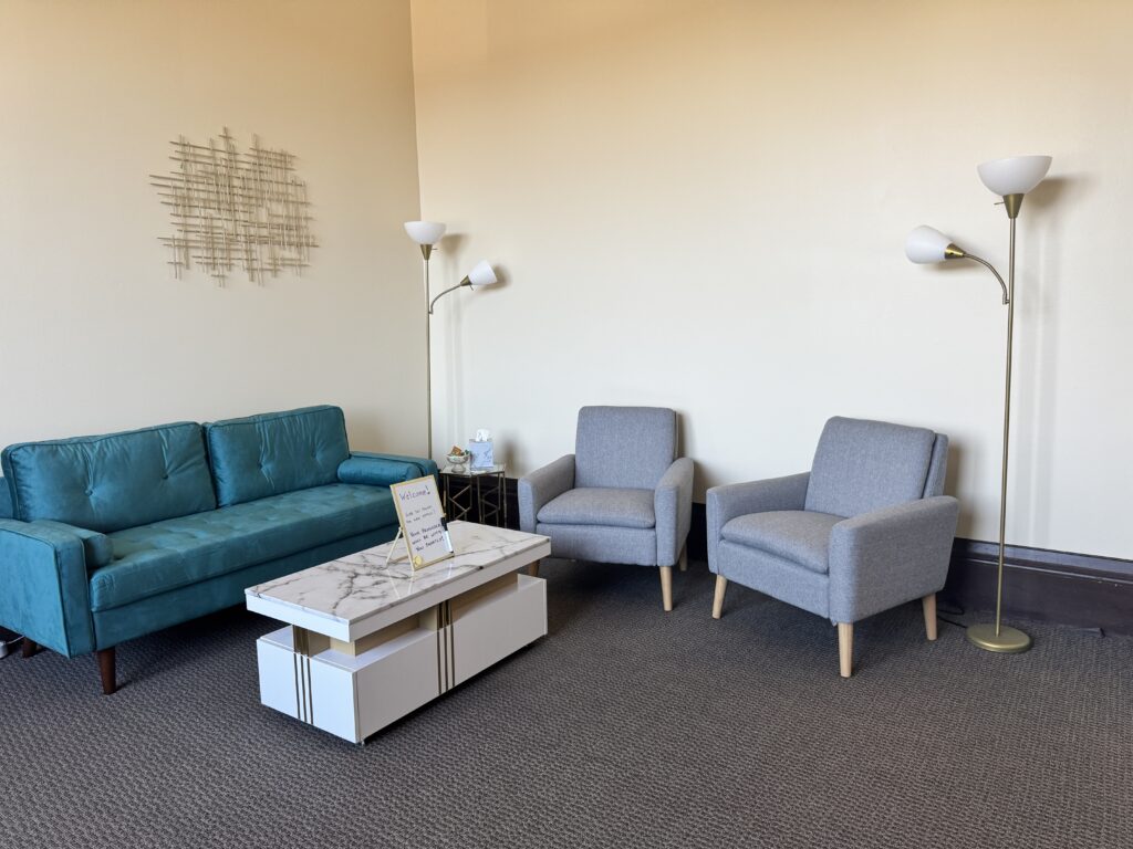 Cozy Waiting Room with cute teal couch and marble table